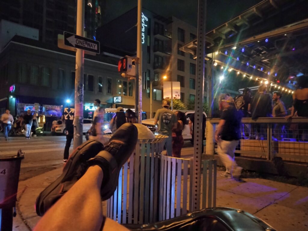 Feet raised resting, watching people on west 6th st