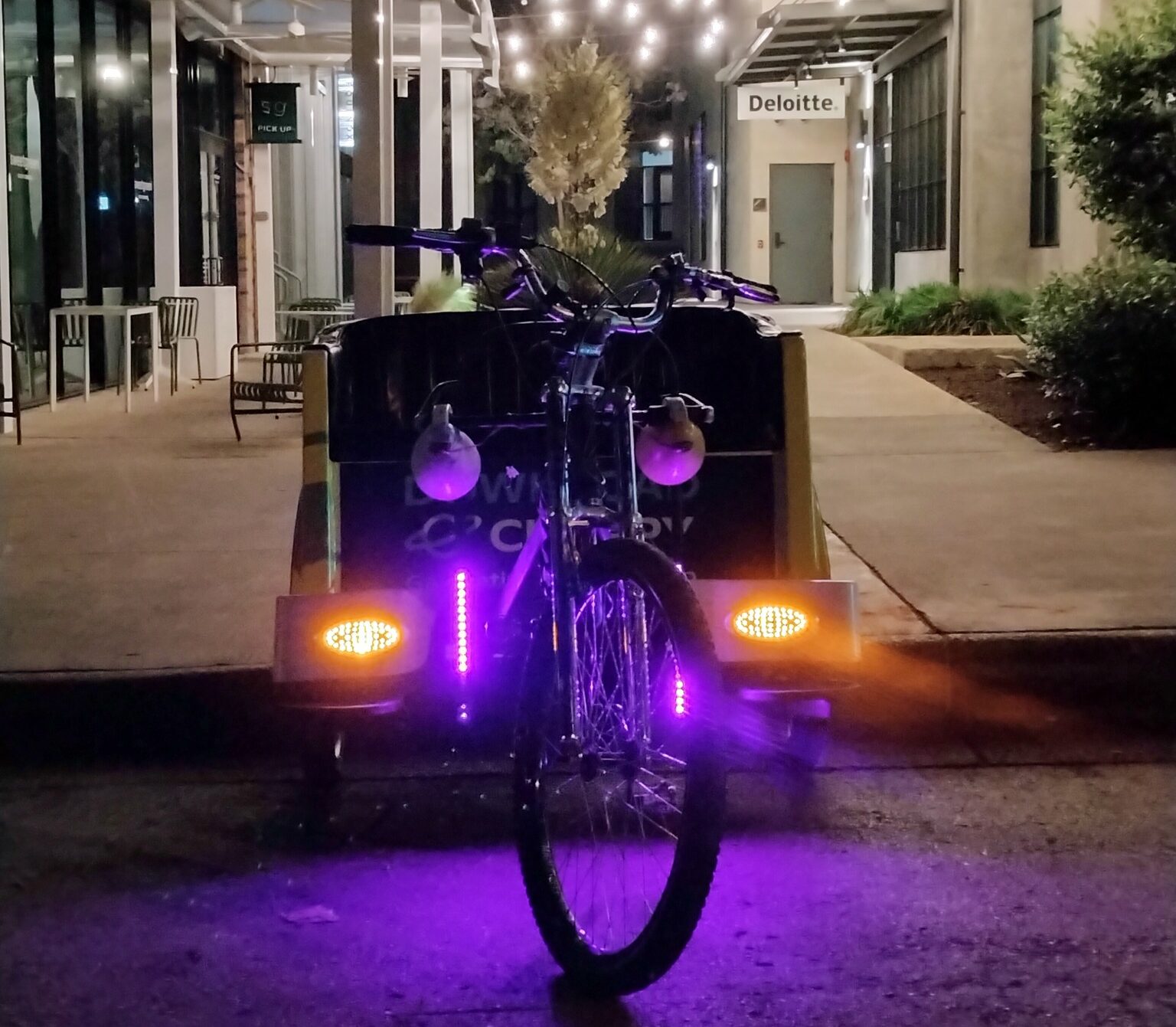 Your Favorite Pedicab parked in front of a blooming yucca on South Congress.